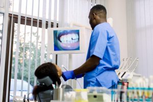 A dental hygienist examining a patient.