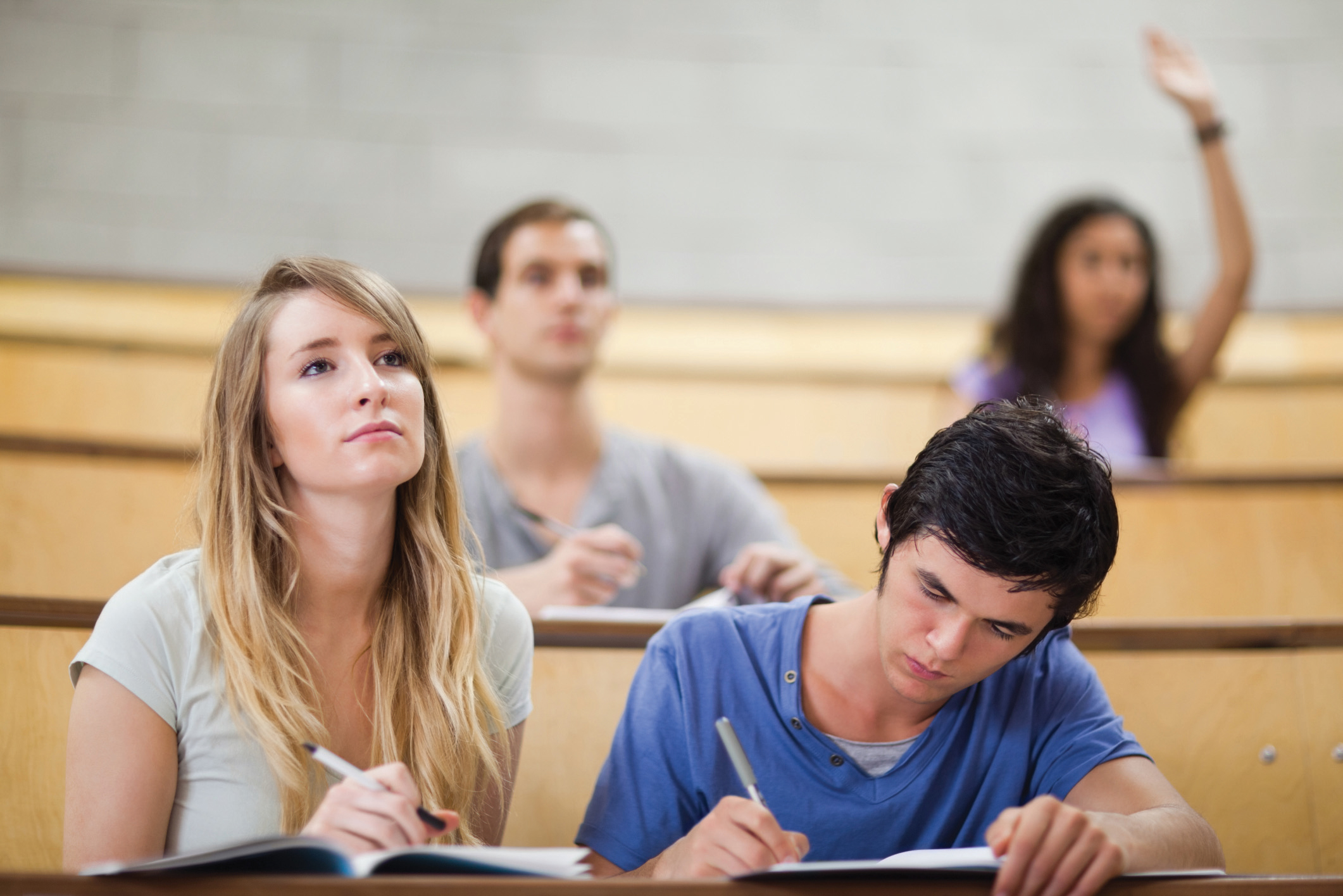 Two students actively listening to an instructor.