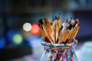 A bowl holding paint brushes.