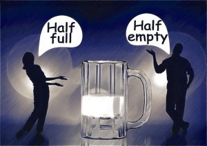 A silhouette of a man and a woman around a mug filled half way with milk. The woman says, "Half full", and the man states "Half empty."